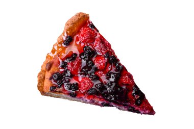 Delicious fresh pie with raspberries and other berries and cheese on a dark plate on a black background