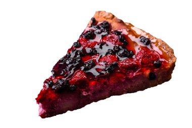 Delicious fresh pie with raspberries and other berries and cheese on a dark plate on a black background