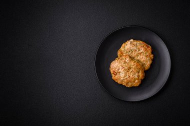 Lezzetli taze kıymalı balık pirzolası. Esmer arka planda baharatlar ve otlarla birlikte.