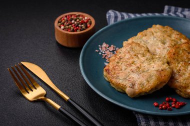 Lezzetli taze kıymalı balık pirzolası. Esmer arka planda baharatlar ve otlarla birlikte.