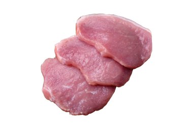 A piece of raw fresh pork on a wooden cutting board with spices and herbs on a dark concrete background