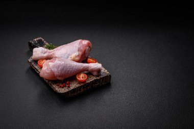 Tuzlu, baharatlı ve çimento kaplı çiğ tavuk bacakları. Evde yemek pişirmek.