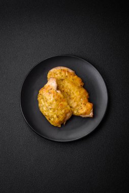 Dijon hardalıyla kızartılmış lezzetli et. Tuz, baharat ve otlarla birlikte koyu beton bir arka planda.