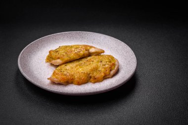 Dijon hardalıyla kızartılmış lezzetli et. Tuz, baharat ve otlarla birlikte koyu beton bir arka planda.