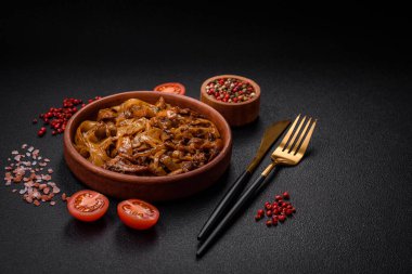 Sebzeli, mantarlı, tuzlu ve baharatlı lezzetli Asya udonu tabağı koyu beton arka planda.