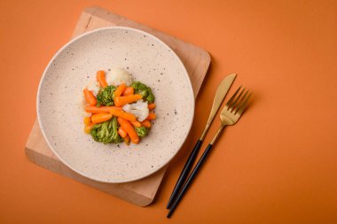 Lezzetli taze sebzeler brokoli, karnabahar, tuz, baharat ve otlarla pişirilmiş havuç.