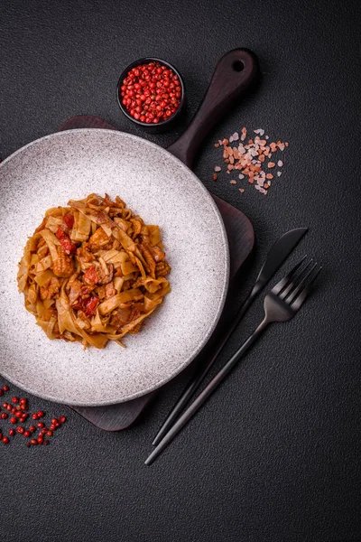 Sebzeli, mantarlı, tuzlu ve baharatlı lezzetli Asya udonu tabağı koyu beton arka planda.