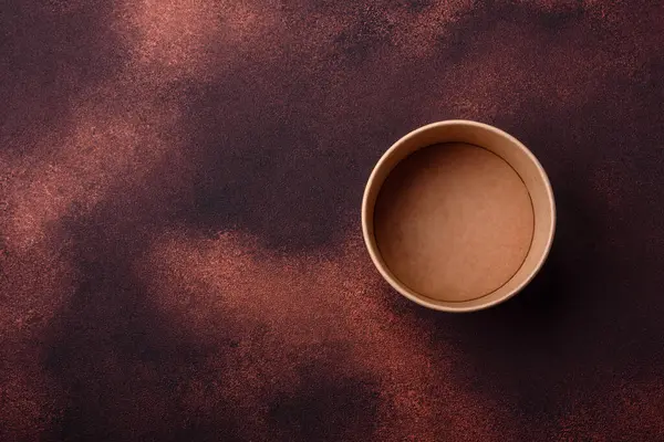 Empty ceramic round plate on dark textured concrete background. Cutlery, preparation for dinner