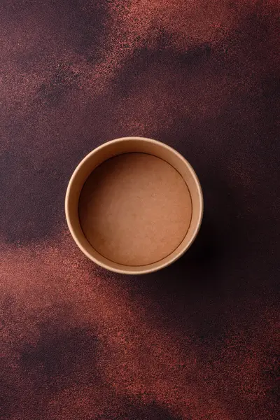 Empty ceramic round plate on dark textured concrete background. Cutlery, preparation for dinner