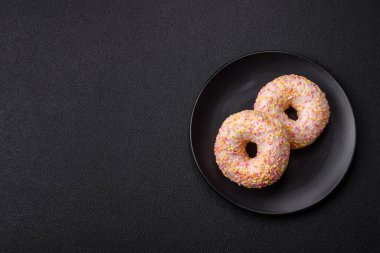 Sade bir arka planda kremalı lezzetli, parlak çörekler. Tatil tablosu özelliği