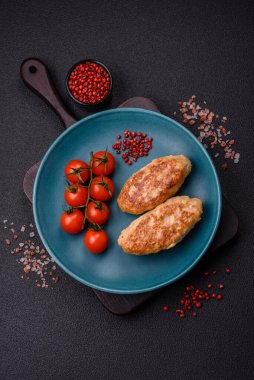 Lezzetli taze kıymalı balık pirzolası. Esmer arka planda baharatlar ve otlarla birlikte.