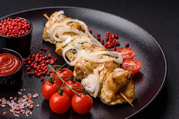 Delicious fresh chicken meat kebab with salt, spices and herbs on a dark concrete background