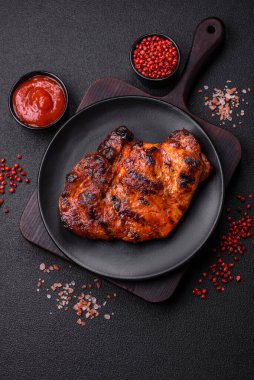 Karanlık bir arka planda taze sulu lezzetli biftek. Baharatlı ve otlu et yemeği.