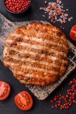 Lezzetli taze ızgara tavuk filetosu, esrarlı baharatlar ve çimento kaplı otlar. Ateşte pişirilmiş bir tabak.