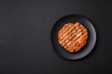 Lezzetli taze ızgara tavuk filetosu, esrarlı baharatlar ve çimento kaplı otlar. Ateşte pişirilmiş bir tabak.