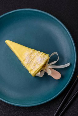 Koyu beton bir arka planda, ahşap bir çubukla meyveli lezzetli bir cheesecake.