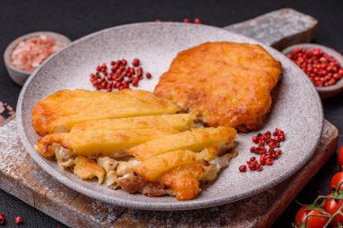 Dijon hardalıyla kızartılmış lezzetli et. Tuz, baharat ve otlarla birlikte koyu beton bir arka planda.