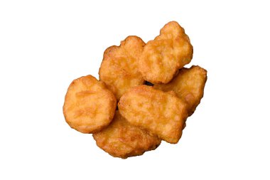 Delicious fresh crispy chicken nuggets on a dark concrete background. Unhealthy food, fast food