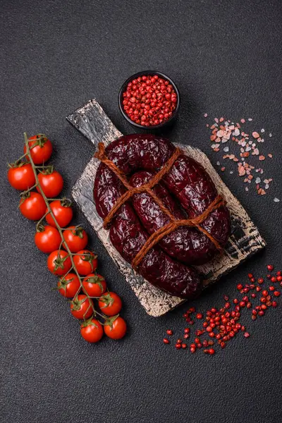 stock image Delicious black blood sausage or black pudding with spices and herbs grilled on a black concrete background