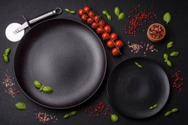 Ingredients salt, spices, herbs and tomatoes on a dark concrete background. Cooking at home