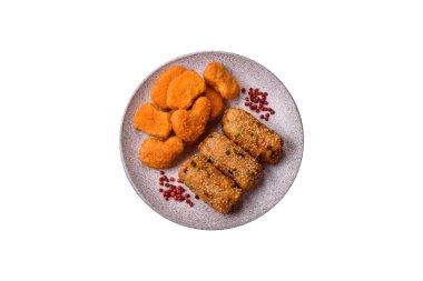 Delicious hearty vegetarian or vegan dish in the form of cutlets or patties consisting of potatoes, carrots, onions and beans on a dark concrete background