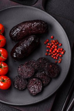 Lezzetli siyah kan sosisi veya siyah beton arka planda ızgara baharat ve otlu kara puding.