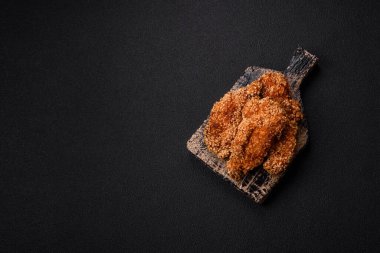 Delicious fresh crispy chicken nuggets on a dark concrete background. Unhealthy food, fast food