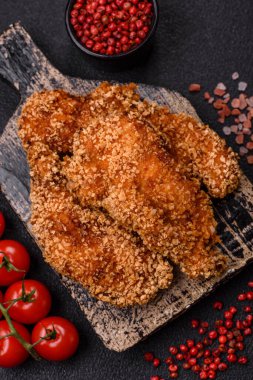 Delicious fresh crispy chicken nuggets on a dark concrete background. Unhealthy food, fast food
