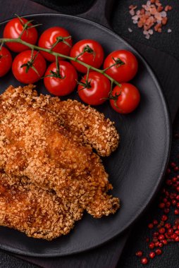 Delicious fresh crispy chicken nuggets on a dark concrete background. Unhealthy food, fast food