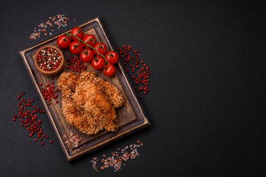 Delicious fresh crispy chicken nuggets on a dark concrete background. Unhealthy food, fast food