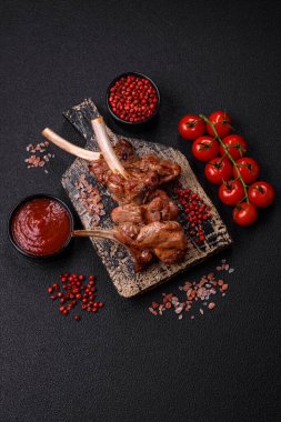 Delicious juicy meat on the bone or rack of lamb or grilled veal with salt, spices and herbs clipart