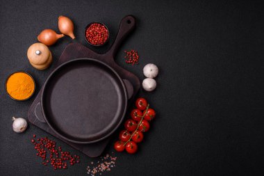 Empty ceramic round plate on dark textured concrete background. Cutlery, preparation for dinner