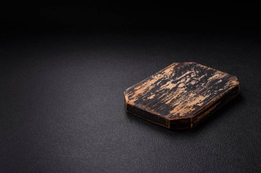 Empty wooden cutting board on dark textured concrete background. Cutlery, preparation for dinner