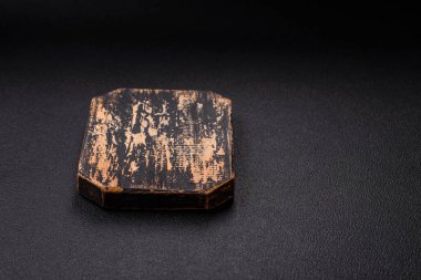 Empty wooden cutting board on dark textured concrete background. Cutlery, preparation for dinner