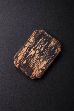 Empty wooden cutting board on dark textured concrete background. Cutlery, preparation for dinner