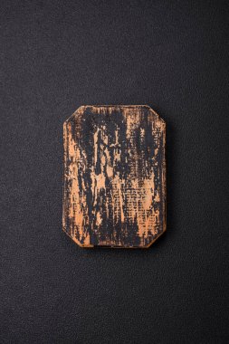 Empty wooden cutting board on dark textured concrete background. Cutlery, preparation for dinner