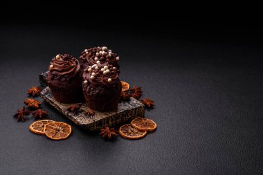 Doldurulmuş lezzetli taze kekler ve koyu beton arka planda çikolata kaplı.