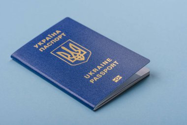 Mavi arka planda biyometrik Ukrayna pasaportu. Turizm ve seyahat teması üzerine kavramsal arka plan