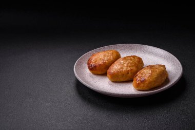 Lezzetli taze kıymalı balık pirzolası. Esmer arka planda baharatlar ve otlarla birlikte.