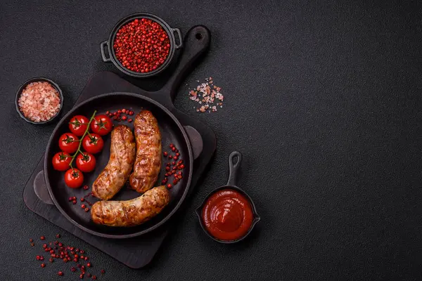 Koyu beton arka planda tuzlu, baharatlı ve otlu kızarmış domuz veya tavuk sosisi.