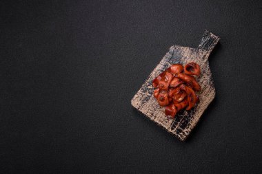 Tuz ve baharatla dilimlenmiş kızarmış sosisler koyu beton arka planda İngiliz kahvaltısı için bir malzeme.