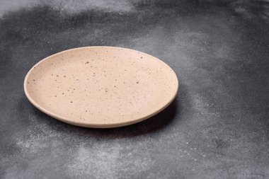 Koyu dokulu arka planda boş seramik tabak. Aile yemeği için mutfak gereçleri hazırlıyorum.