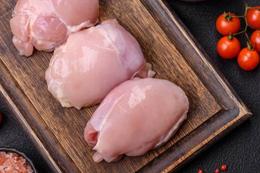 Koyu beton bir masada baharat ve otlarla taze tavuk filetosu. Et yemekleri için hazırlık.