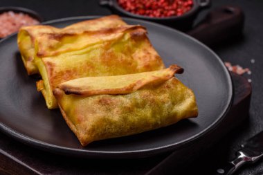 Koyu beton arka planda seramik tabakta ev yapımı krep.