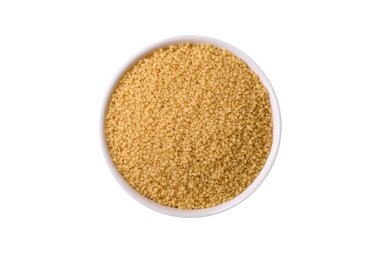 Koyu beton arka planda buğday lapası kuskus taneleri. Lezzetli, besleyici bir kahvaltı hazırlıyorum.