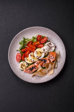 Somon, marul, domates, yumurta, tuz ve baharatlı leziz taze sezar salatası.