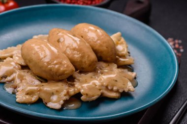 Fish or meat quenelles with delicate mushroom sauce, salt and spices on a dark concrete background clipart