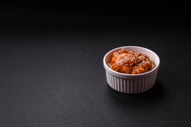 Asya yemekleri tatlı ve ekşi soslu haşlanmış pirinç, koyu beton arka planda baharatlar ve otlar.