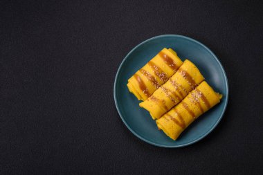 Koyu beton arka planda doyurucu bir kahvaltı için farklı dolguları olan tatlı ya da lezzetli bir krep.