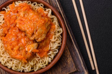 Koyu beton arka planda balık ve soslu pirinç eriştesi, tuz ve baharat.